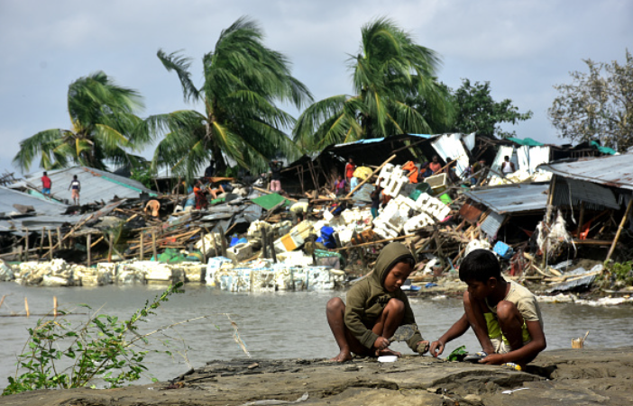 Refugees in the Shadows: Climate Displacement and the Case for a Two-Track Protection Framework